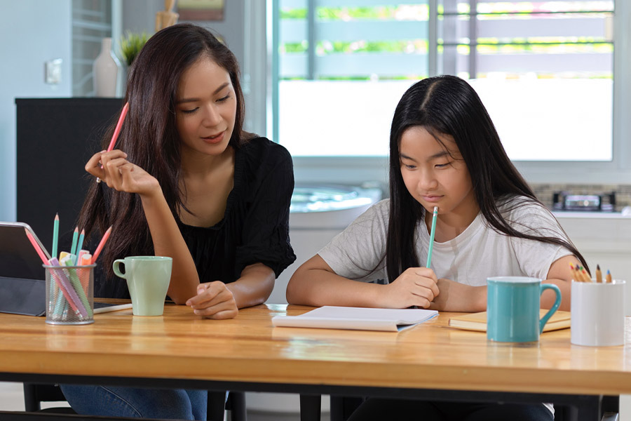 student and tutor together at a desk in Durham